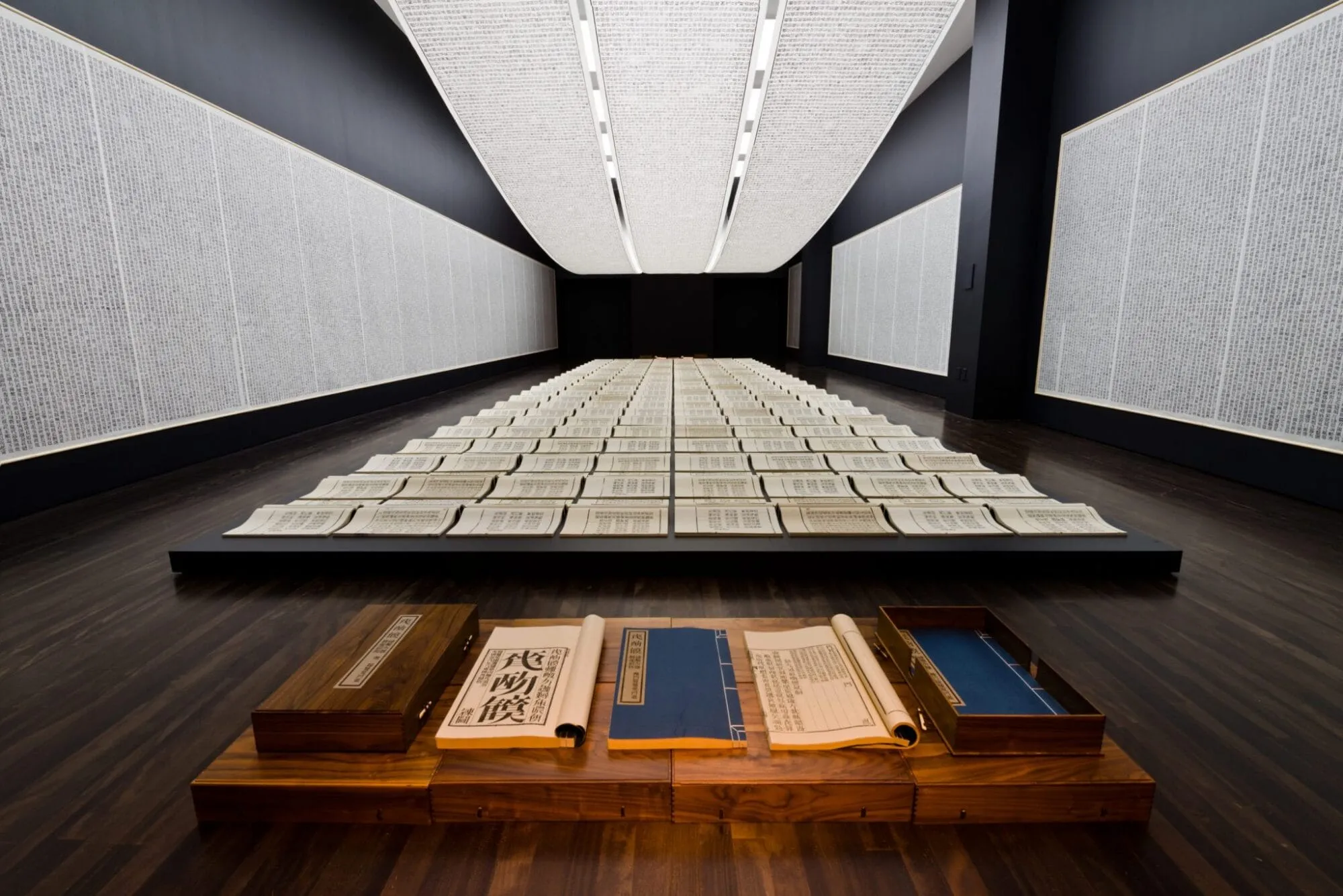 An installation of books, wall panels, and hanging scrolls covered in thousands of invented characters that look readable but carry no meaning. Xu Bing, [Book from the Sky](https://blantonmuseum.org/exhibition/xu-bing-book-from-the-sky/), ca. 1987–91. Installation view at the Blanton Museum of Art, 2016. Courtesy of Xu Bing Studio.